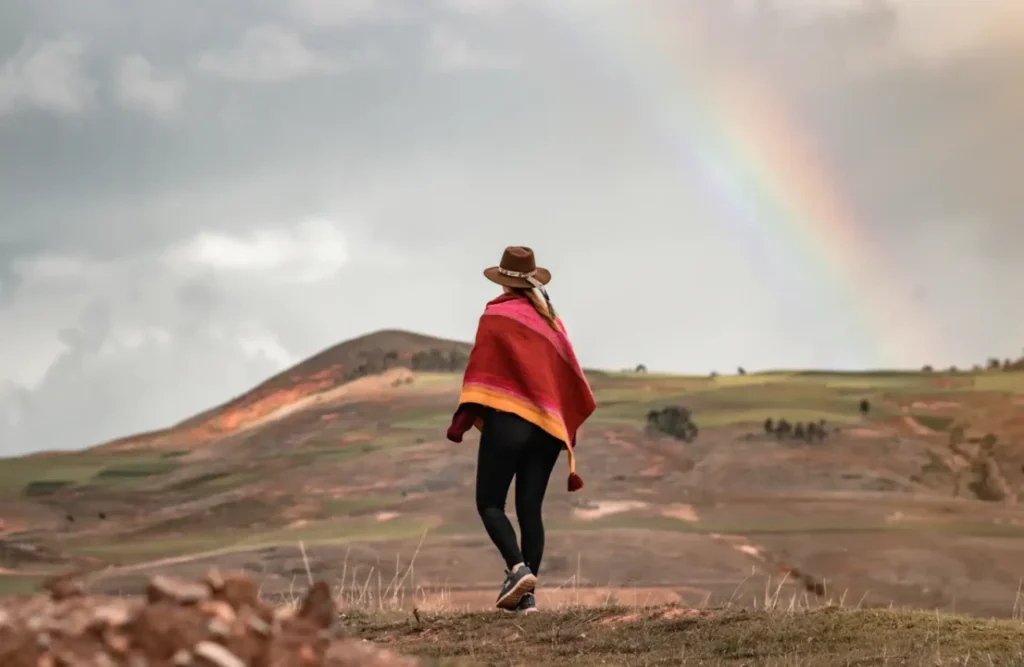 A tourists hikes the Rainbow Mountain route