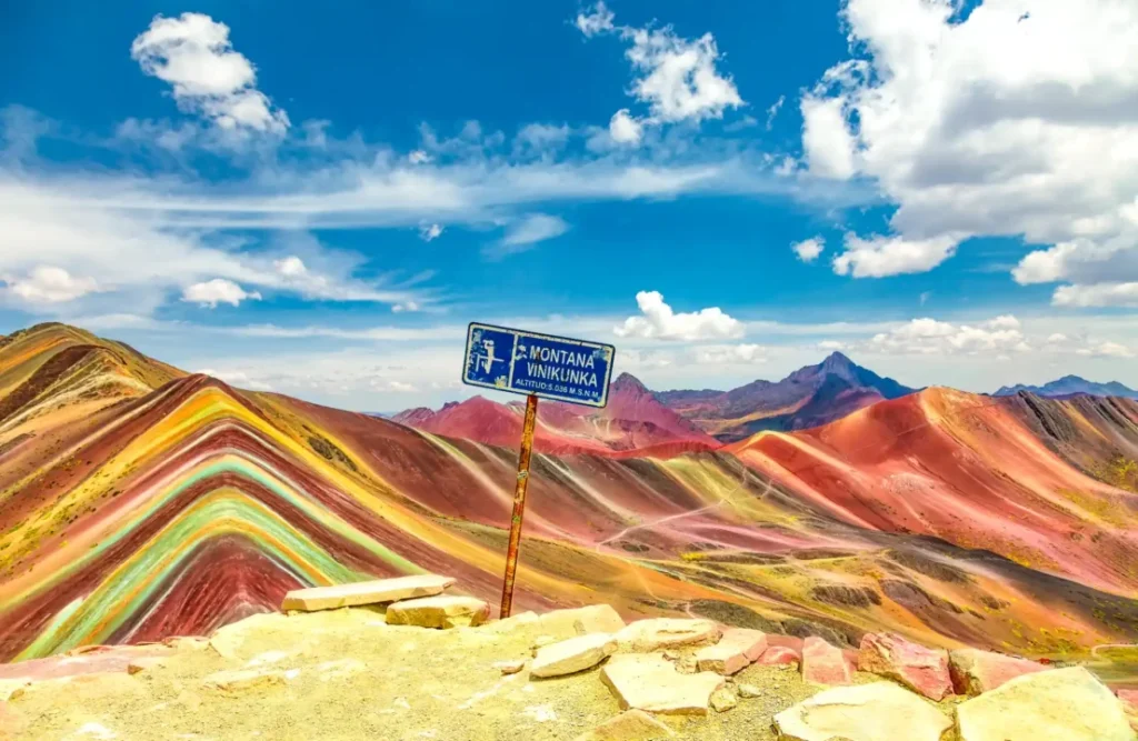 Vinicunca's entrance post sign indicates the 16400 feet altittude over the sea level