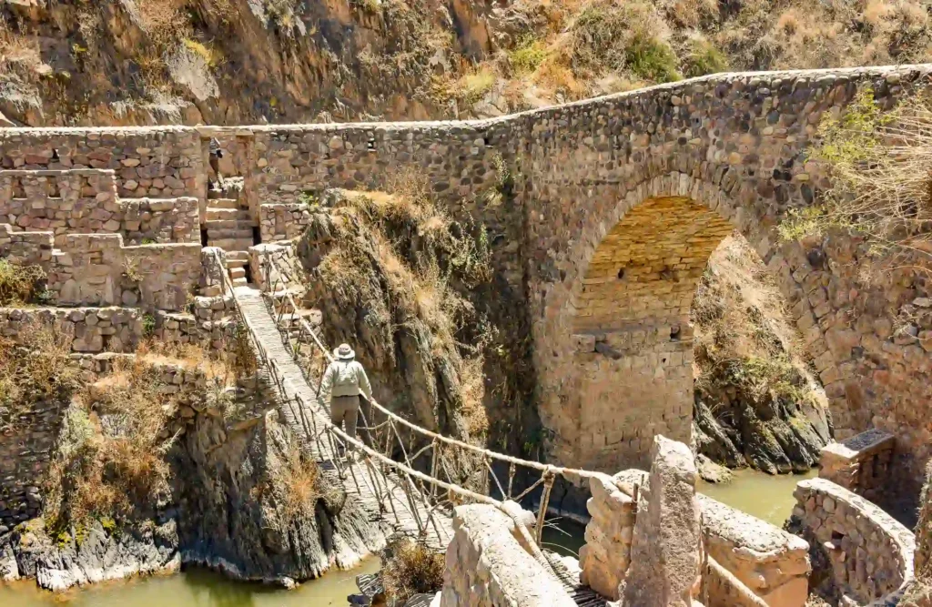 A person crosses the inca bridge located in Checacupe, Province of Canchis in Cusco's region