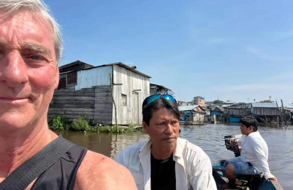 A tourist takes a picture as he leaves Iquitos's outskirts.