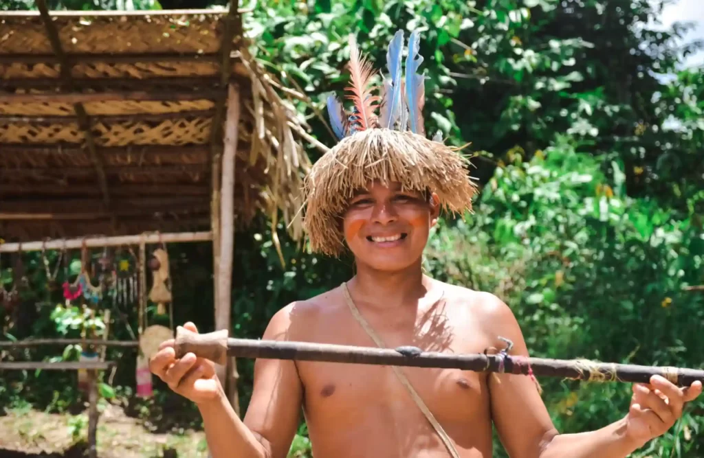 An Amazon native hunter shows one of his tools for the camera